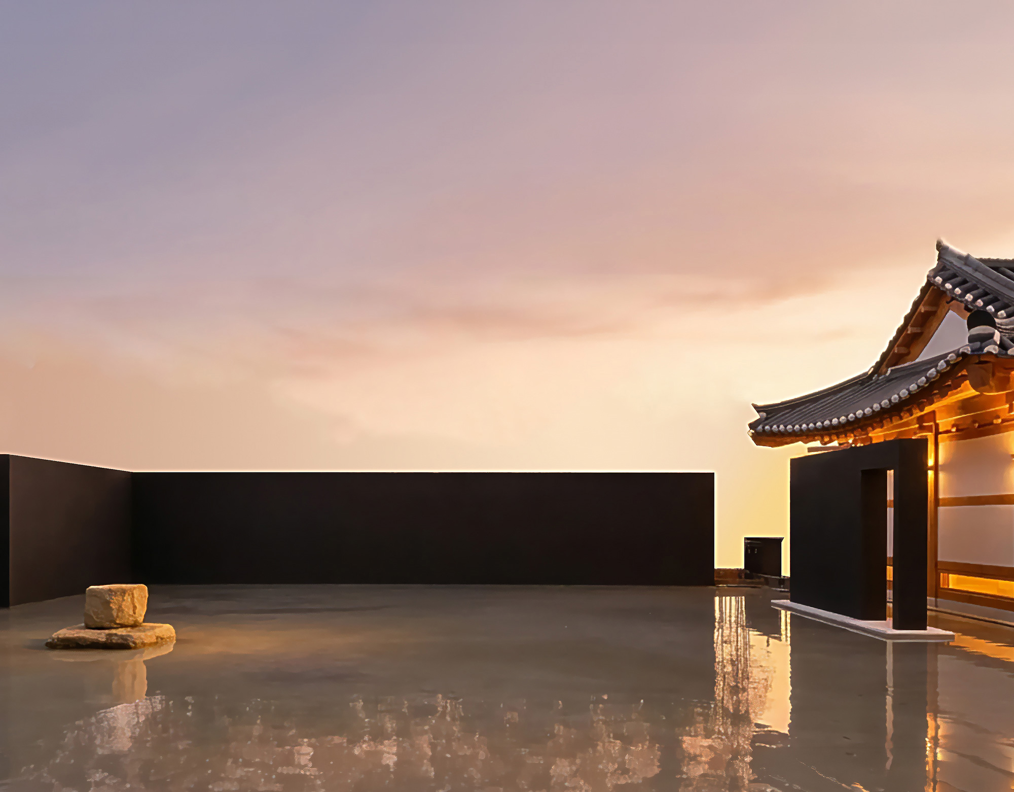 The water garden meeting the eaves of the hanok at sunset