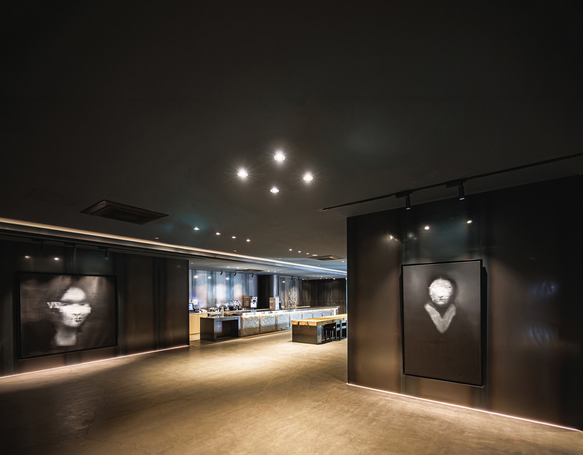Interior of the gallery cafe o's suwon with portrait paintings on display