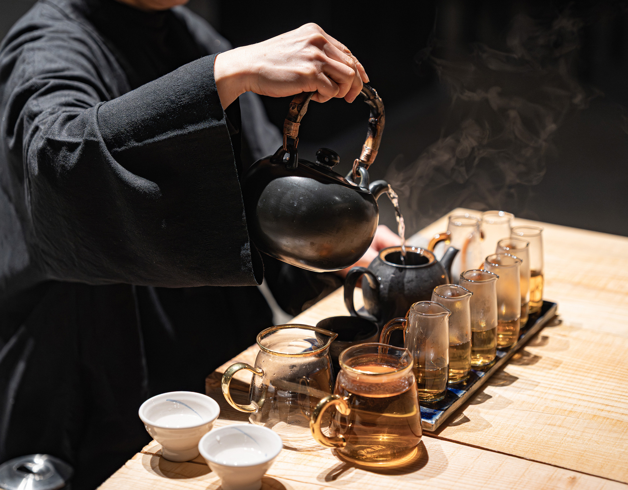 A tea ceremony with steam rising from a teapot