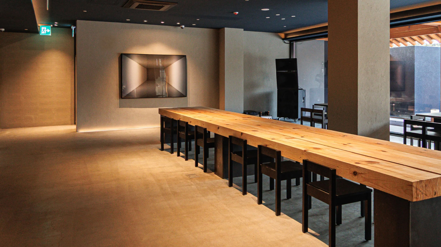 Inside O's Suwon gallery with a solid wood table