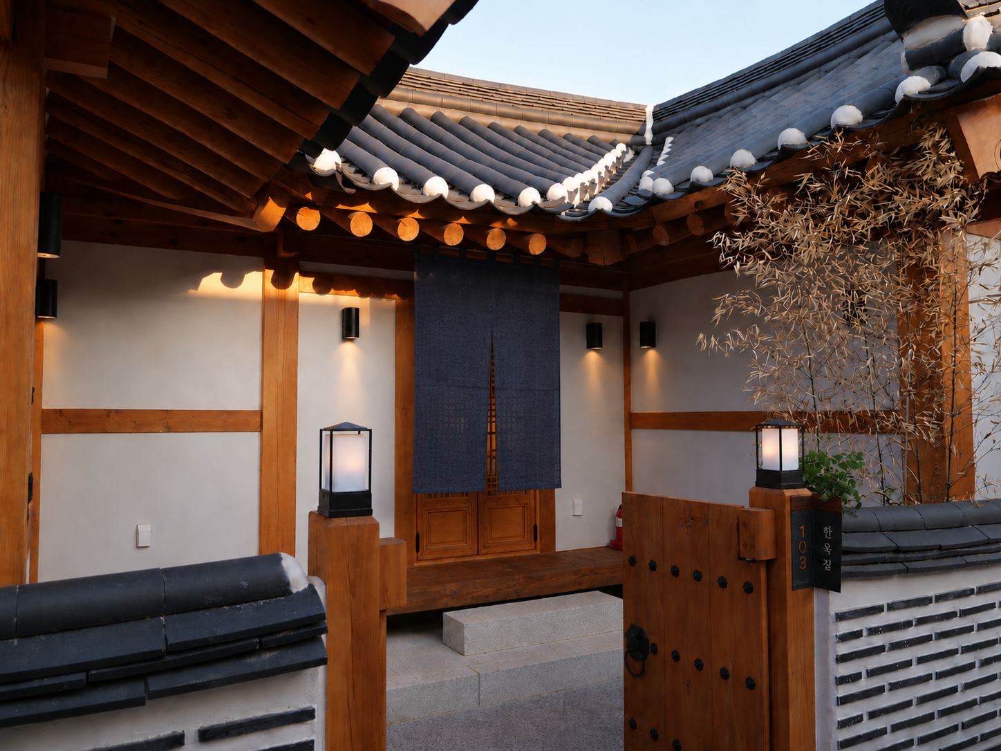 The gate in the evening hung with a blue noren fabric