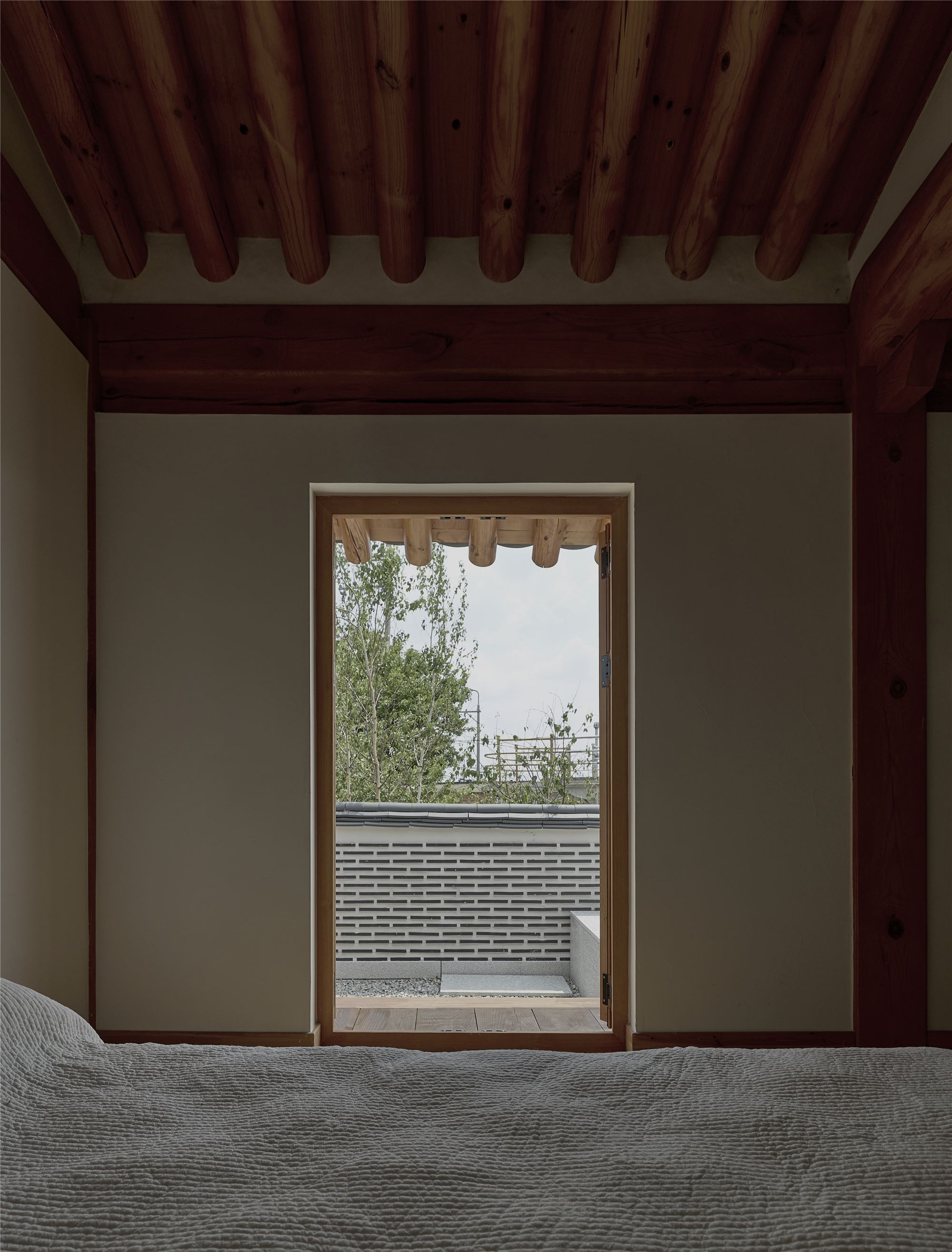 The courtyard seen through the door from the bed