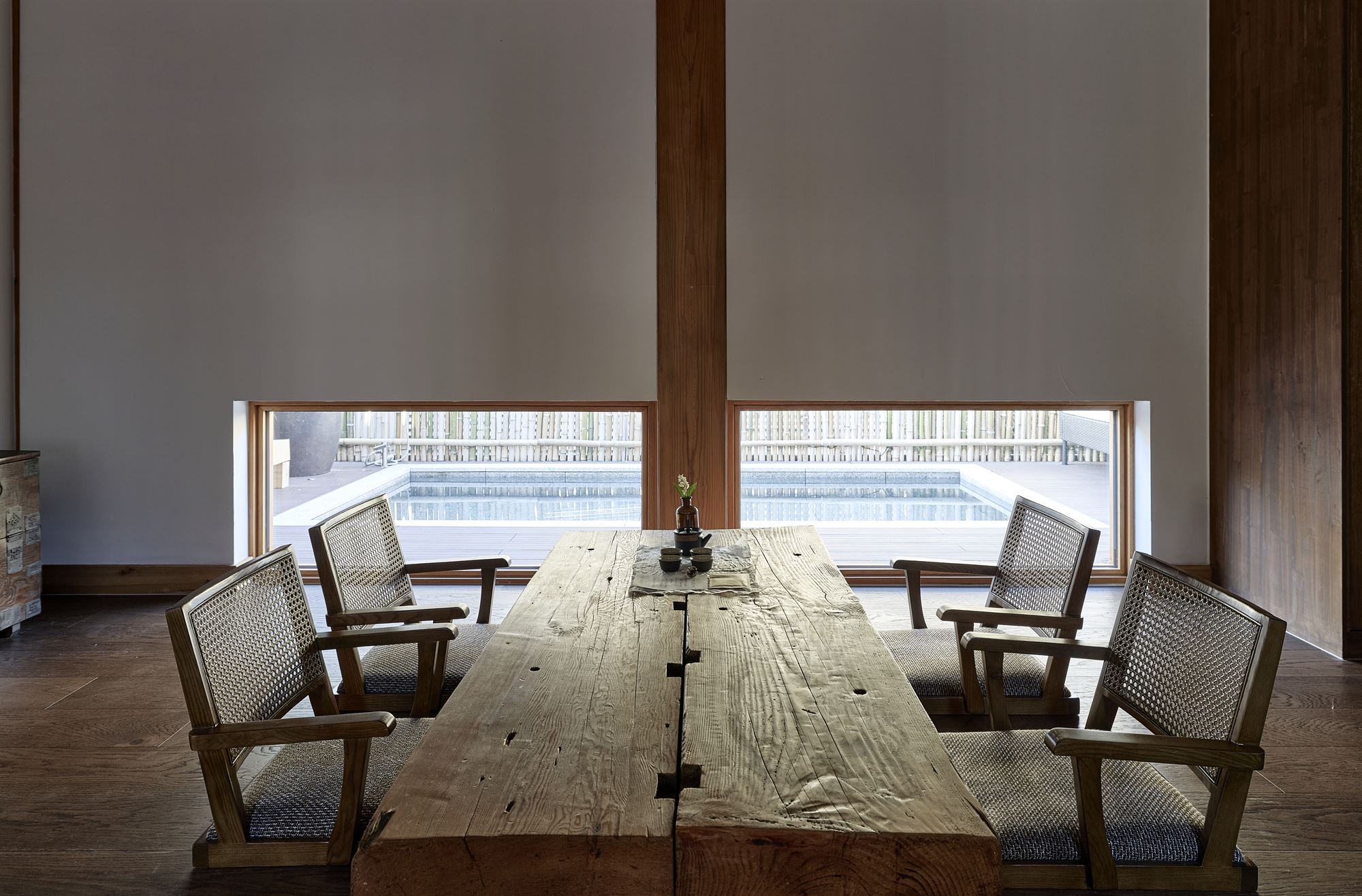A wooden low table in tea room looking out toward the outdoor spa