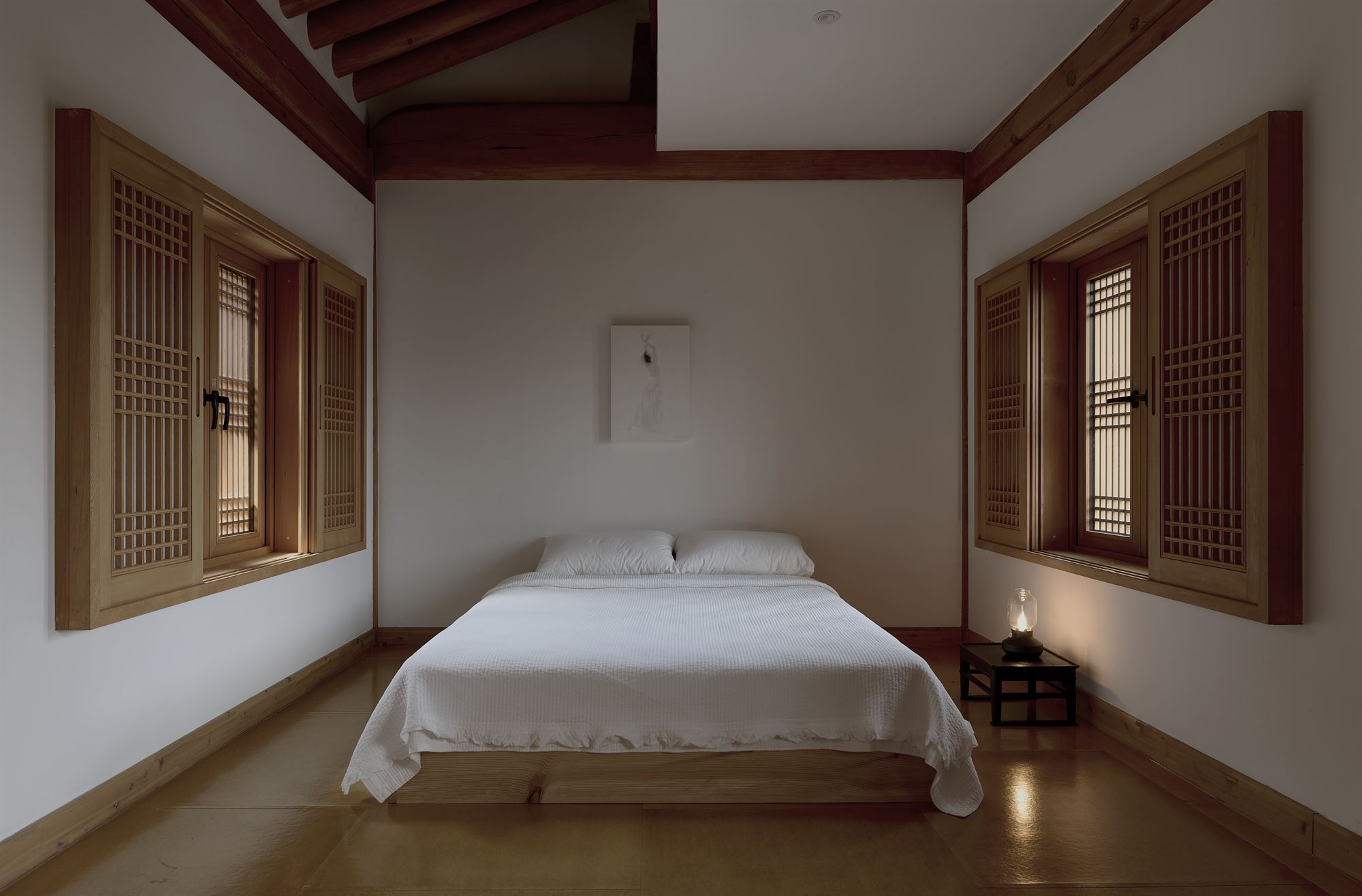An evening bedroom lit by a single lantern