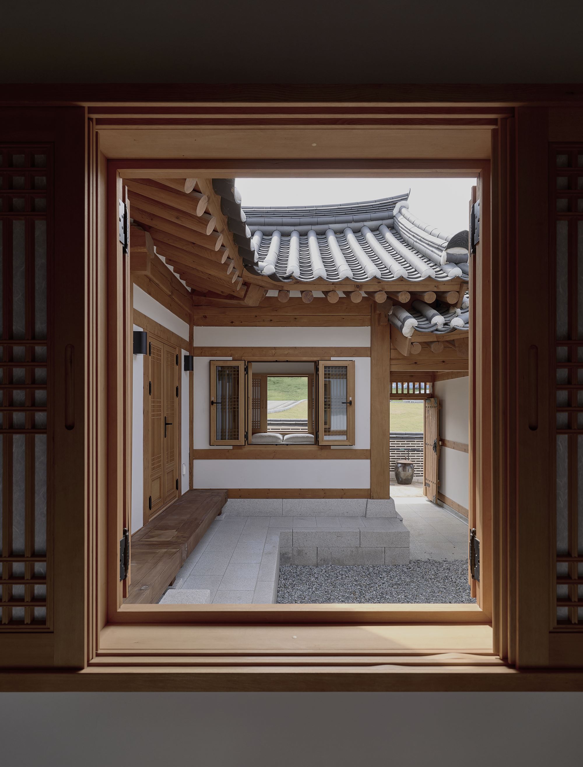 inner courtyard opening beyond the frame of the paper window