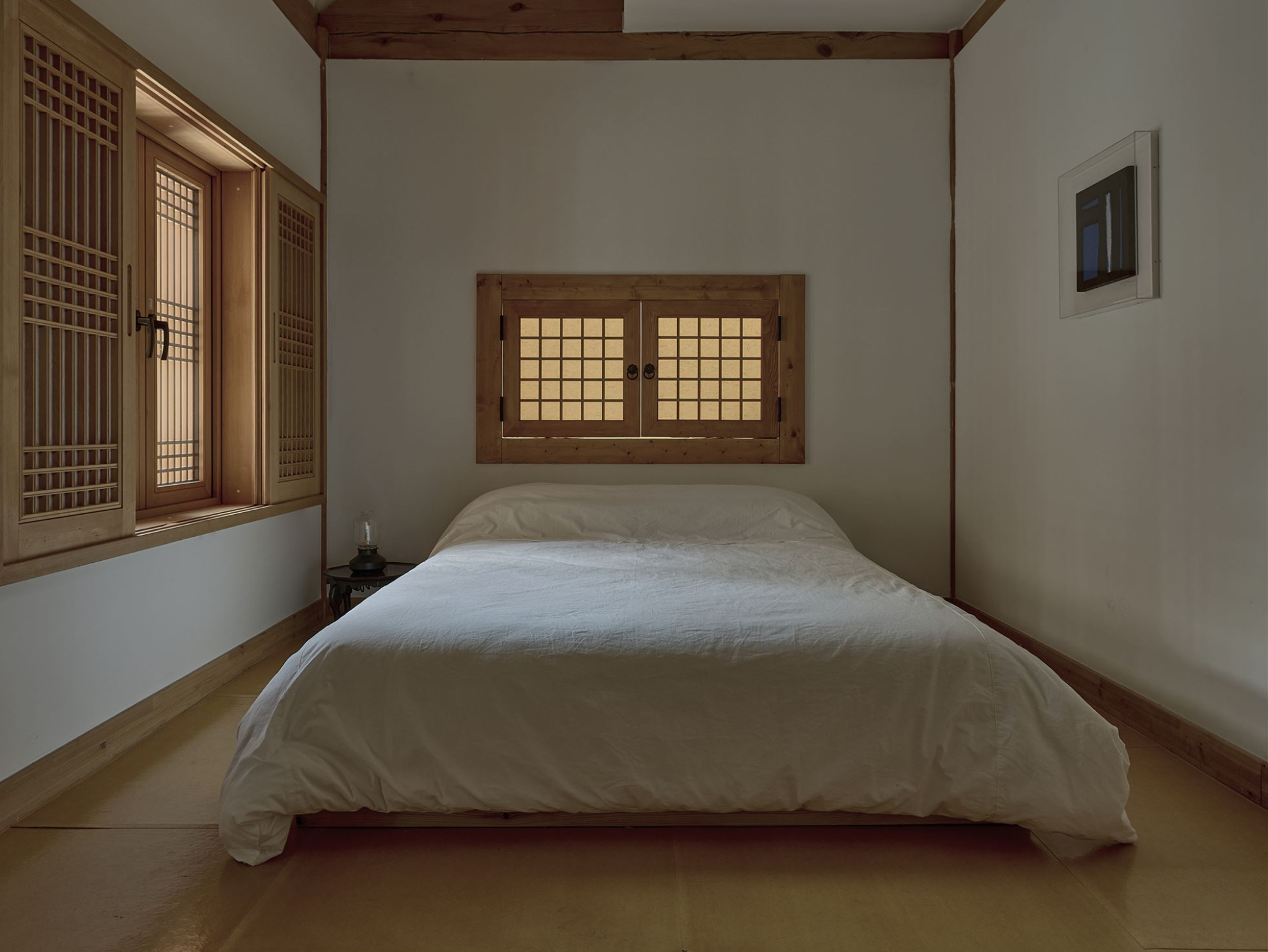 An ondol bedroom softened by lattice paper windows