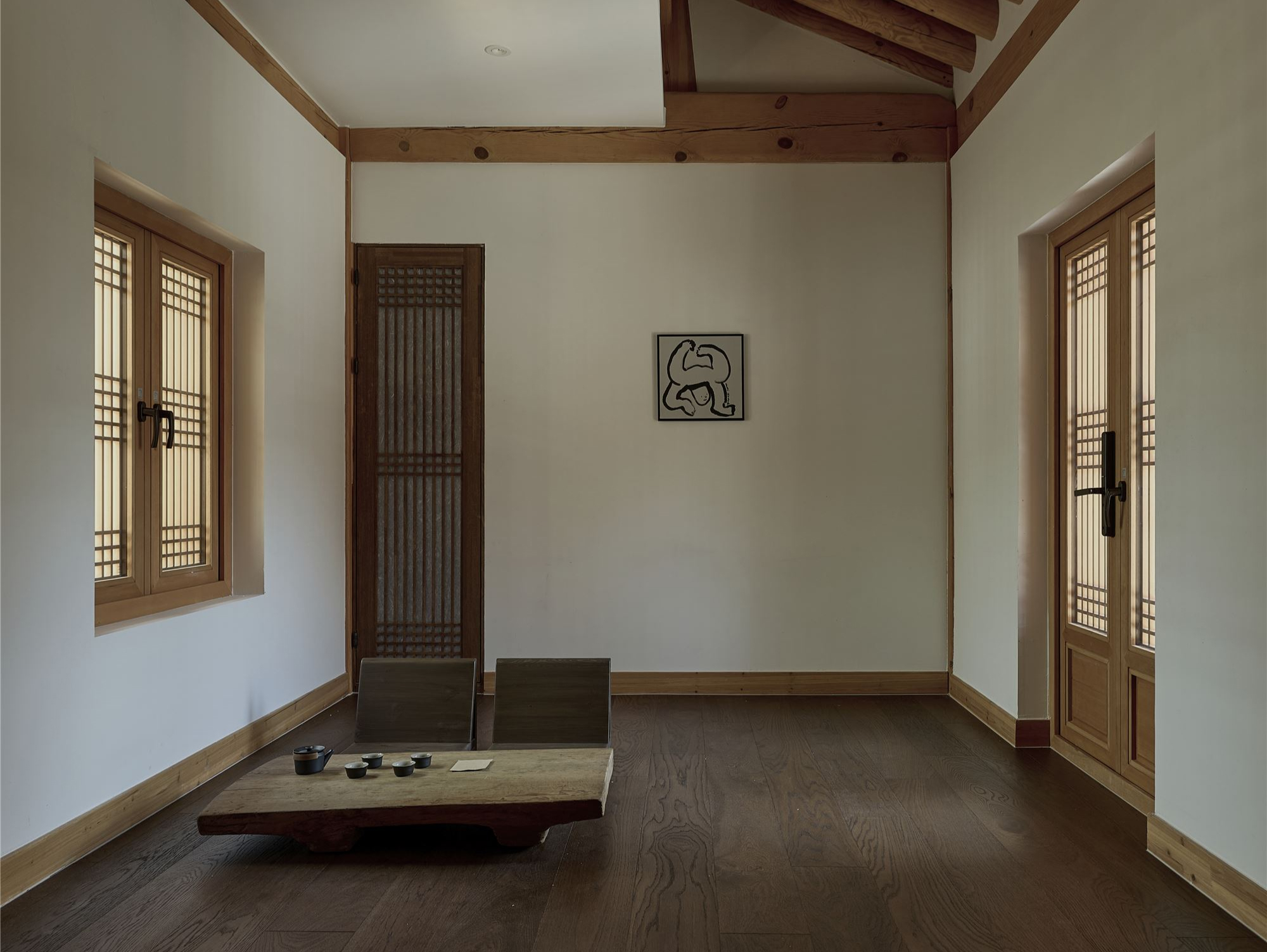 The tea room with a low table set beneath the rafters