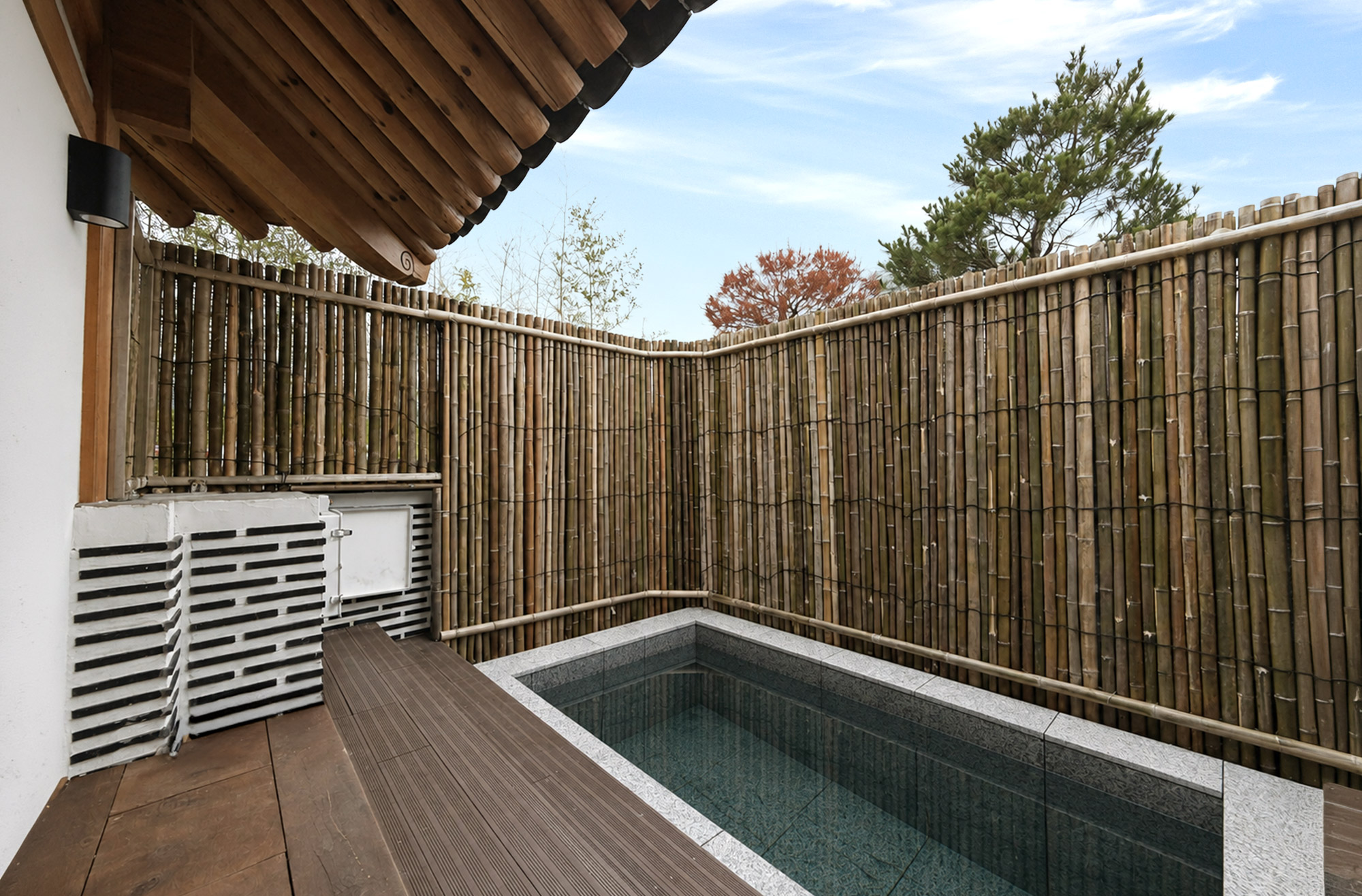 A view of the hot bath where tiled roofs and bamboo fences meet