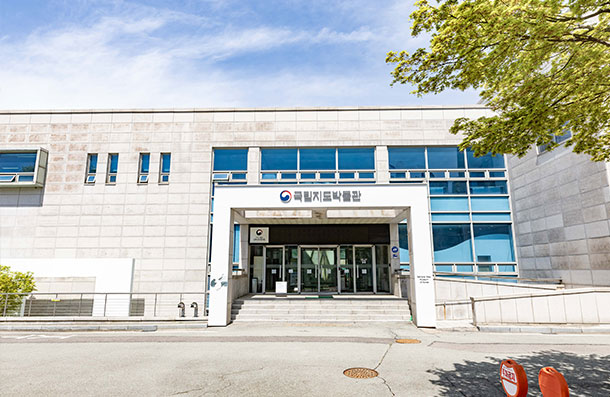 Front exterior of the National Map Museum, showing the granite-finished entrance and signboard